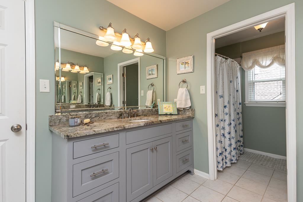 1725 John Ridge Drive Collierville, TN 38017 - Photo 23 of 34 a bathroom with a granite countertop sink a large mirror and a shower