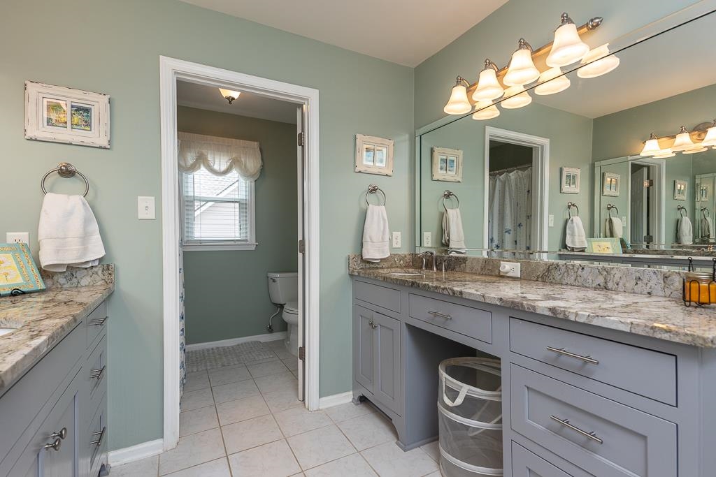 1725 John Ridge Drive Collierville, TN 38017 - Photo 24 of 34 a bathroom with a granite countertop sink and a mirror