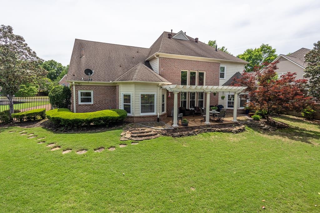1725 John Ridge Drive Collierville, TN 38017 - Photo 31 of 34 a front view of a house with swimming pool having outdoor seating