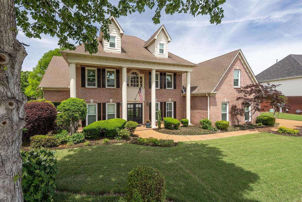 1725 John Ridge Drive Collierville, TN 38017 - Photo 32 of 34 a front view of a house with a yard