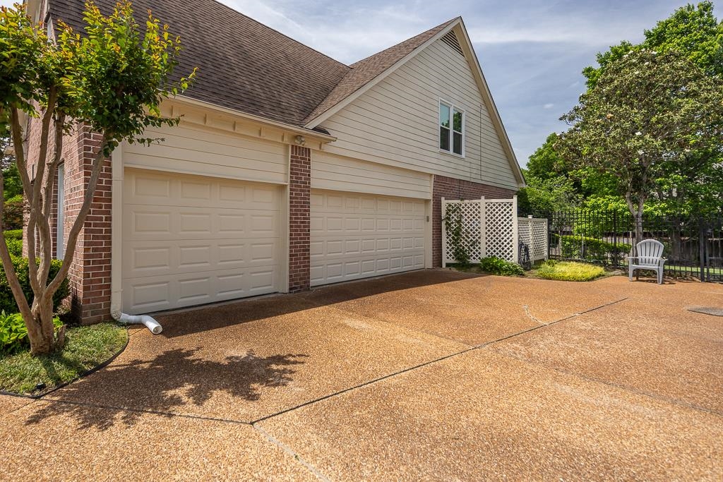 1725 John Ridge Drive Collierville, TN 38017 - Photo 6 of 34 a backyard of a house with yard and garage