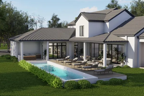 a front view of a house with garden and patio