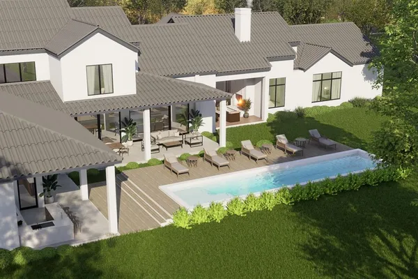 a view of a house with backyard and sitting area