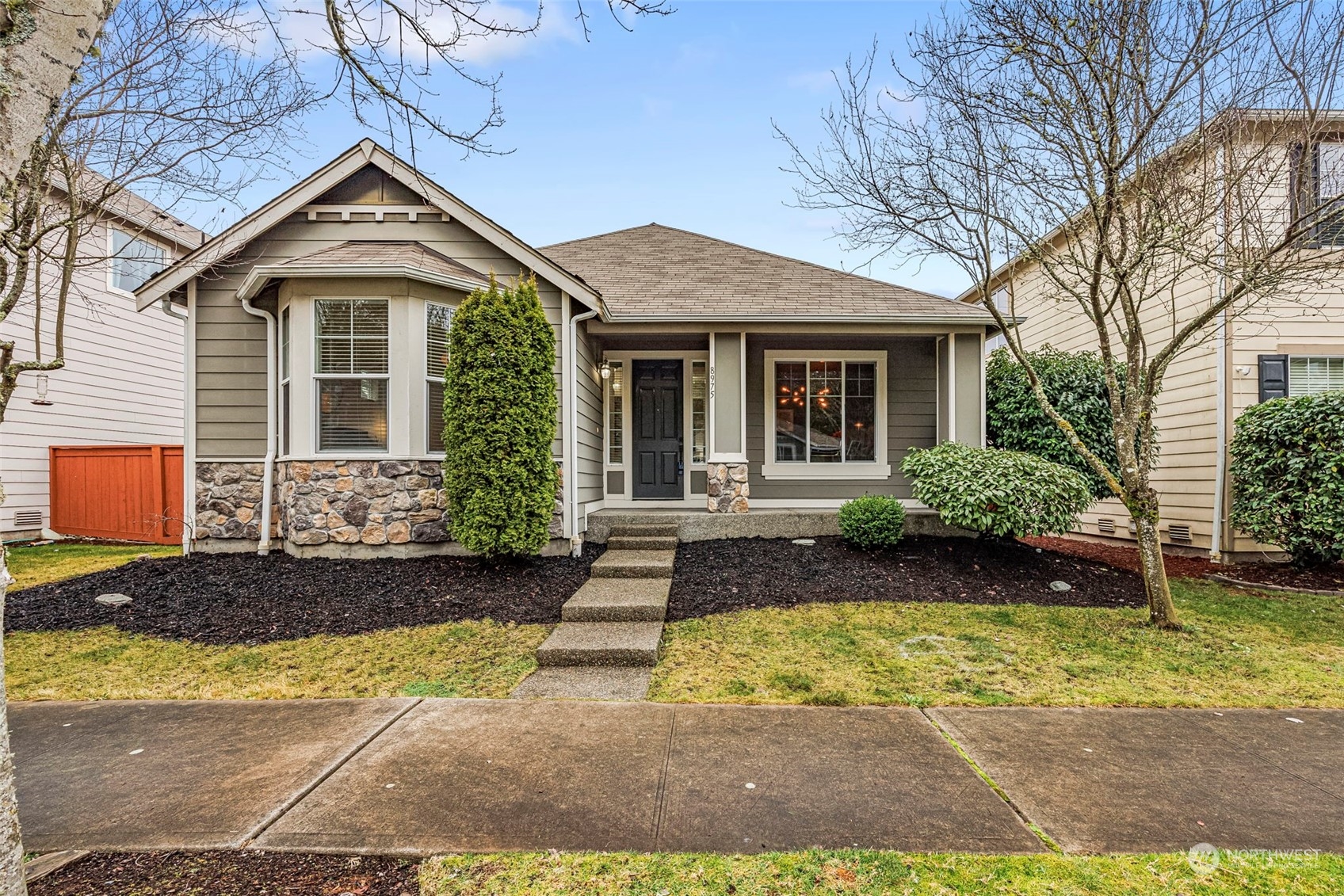8975 Campus Meadows Loop Northeast Lacey, WA 98516 - Photo 1 of 36 a front view of a house with garden