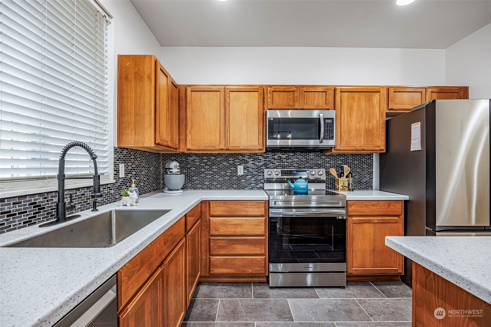8975 Campus Meadows Loop Northeast Lacey, WA 98516 - Photo 23 of 36 a kitchen with stainless steel appliances granite countertop a sink stove and refrigerator
