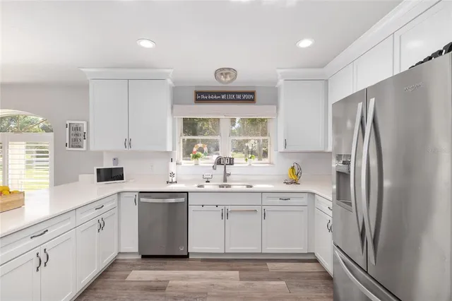 a view of a patio with table and chairs and floor to ceiling window