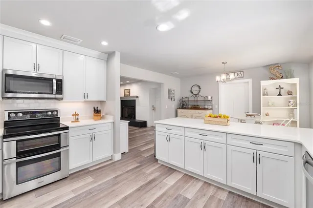 a dining room with furniture and a floor to ceiling window