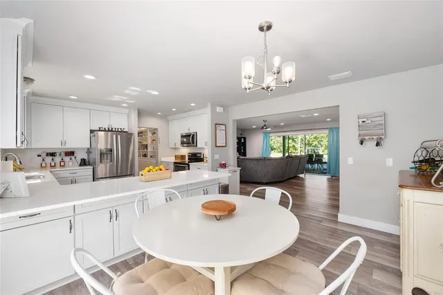 a view of a patio with table and chairs under an umbrella