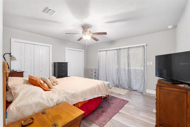 a aerial view of a house next to a big yard and large trees