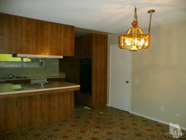 5332 Parkmor Road Calabasas, CA 91302 - Photo 3 of 10 a kitchen with a sink and cabinets