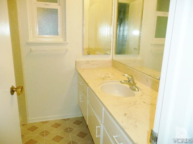 5332 Parkmor Road Calabasas, CA 91302 - Photo 9 of 10 a bathroom with a granite countertop sink and a mirror