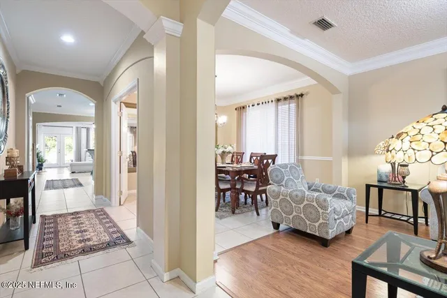 a view of a dining room with furniture and chandelier