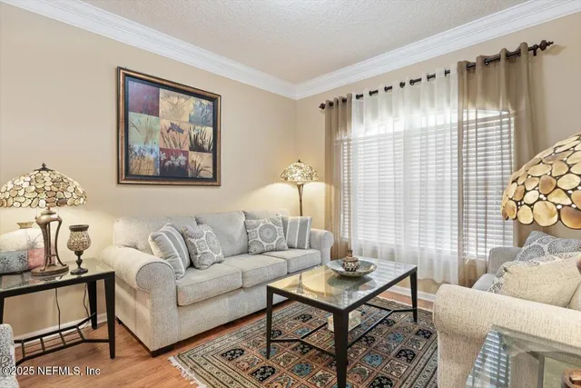 a view of a dining room with furniture and chandelier