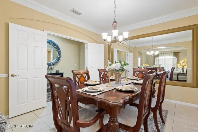 a view of a dining room with furniture and chandelier