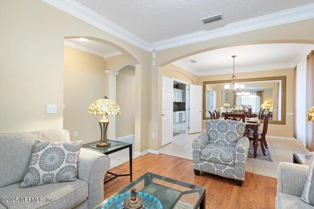 a living room with furniture windows and a flat screen tv