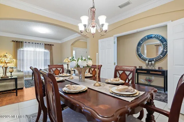 a kitchen with stainless steel appliances granite countertop a stove a refrigerator a kitchen island a table and chairs