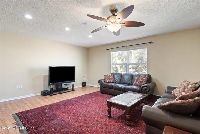 an aerial view of a house with a garden and lake view