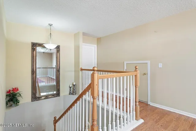 an aerial view of residential houses with outdoor space and lake view