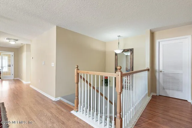 an aerial view of residential houses with outdoor space and river
