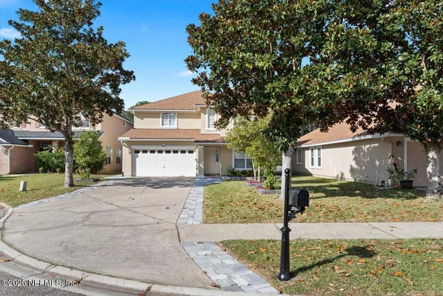 a front view of a house with a yard and garage
