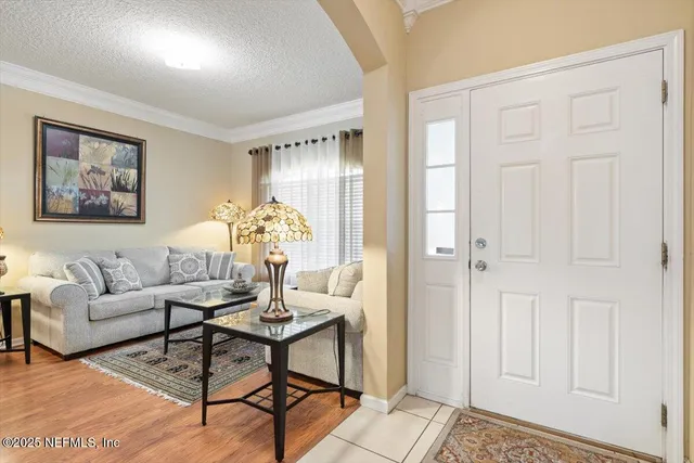 a living room with furniture and a chandelier