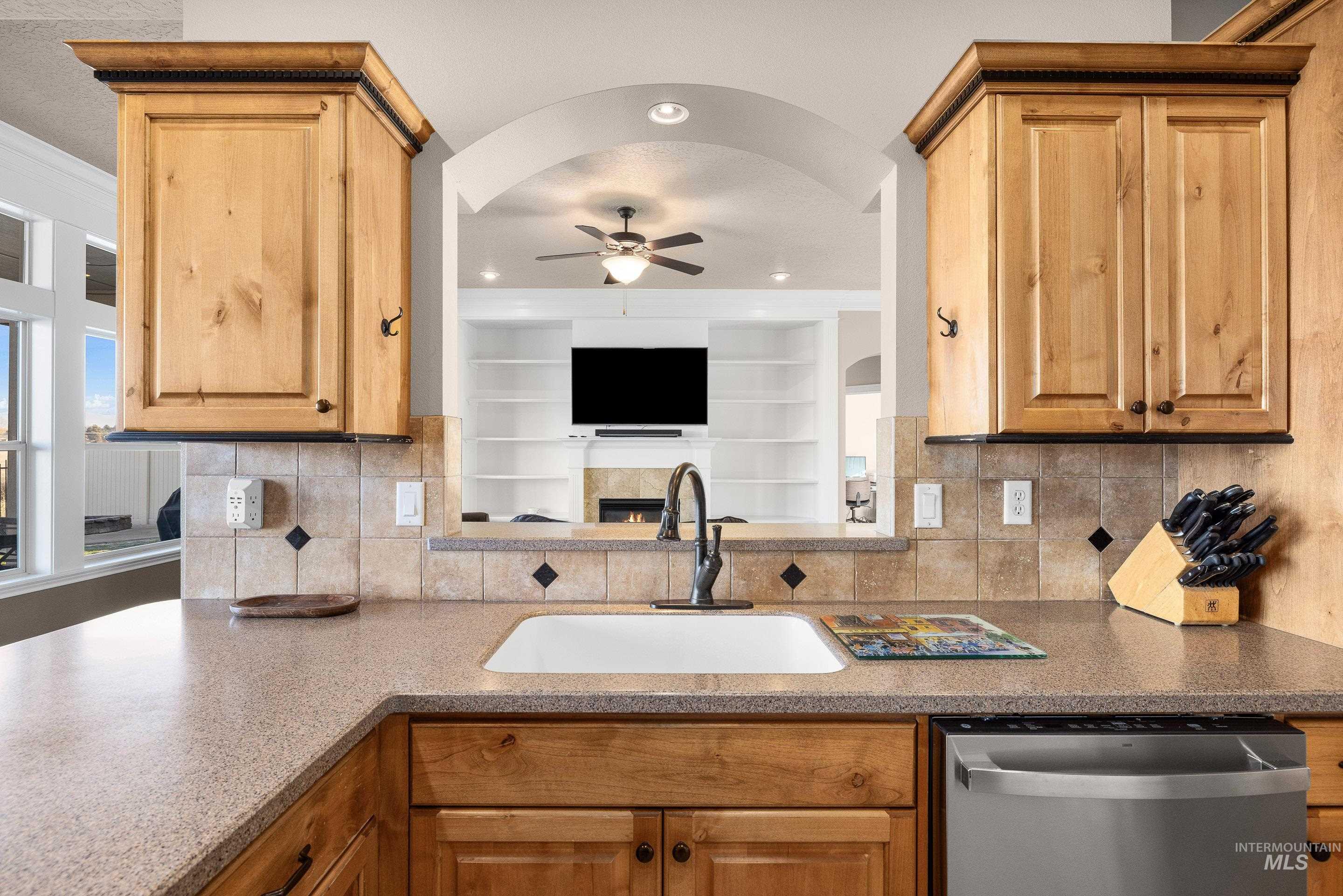 2208 East Sicily Street Meridian, ID 83642 - Photo 20 of 50 Kitchen with dishwasher, decorative backsplash, dark stone counters, and a ceiling fan