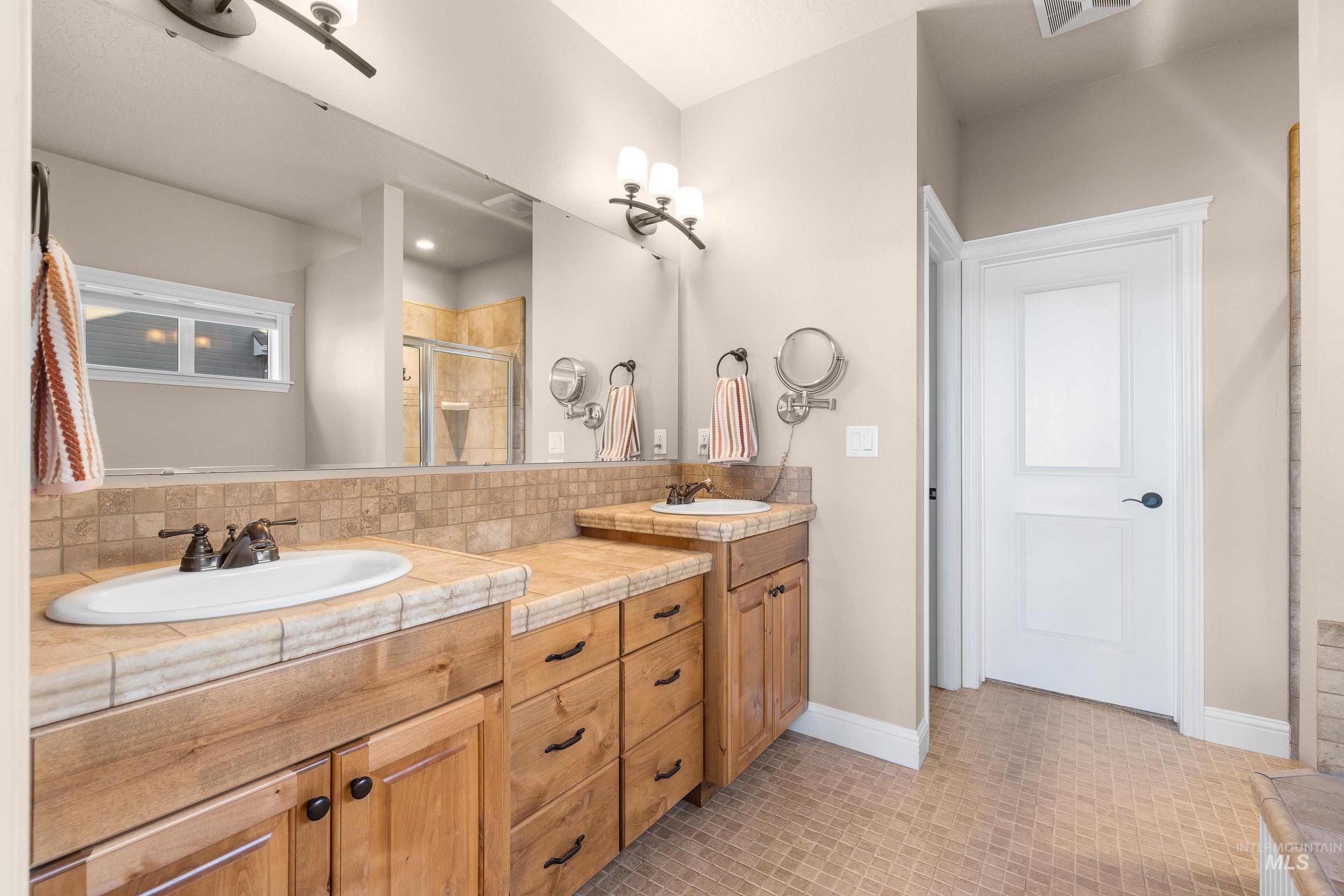 2208 East Sicily Street Meridian, ID 83642 - Photo 24 of 50 Full bath featuring a shower stall and double vanity