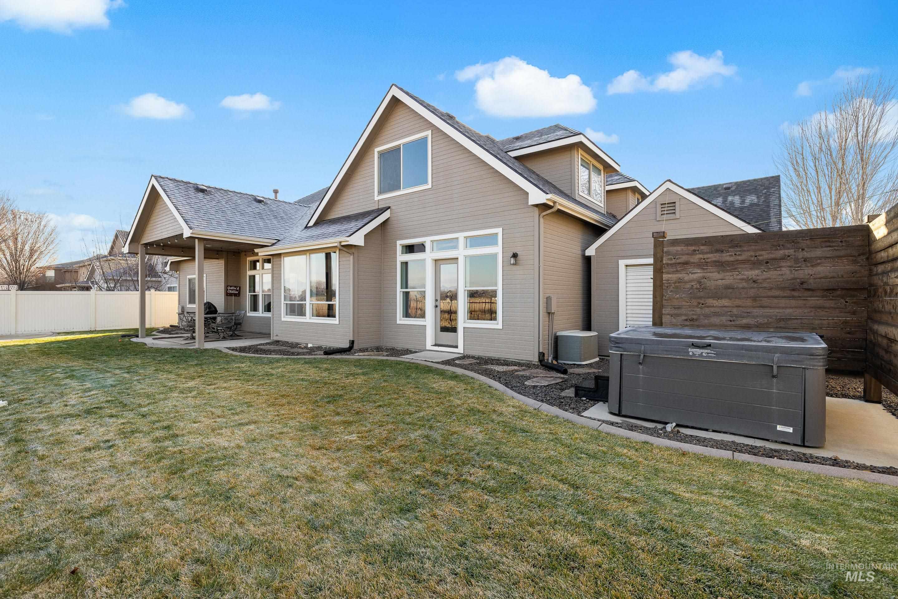 2208 East Sicily Street Meridian, ID 83642 - Photo 49 of 50 Back of house featuring a patio, a fenced backyard, and a hot tub