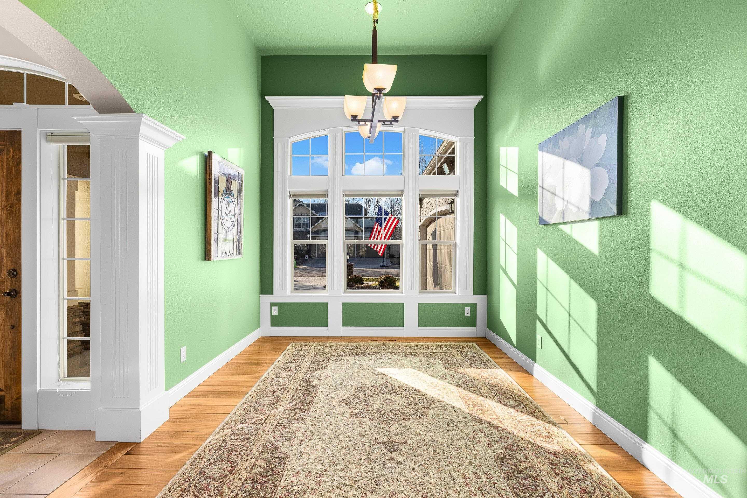 2208 East Sicily Street Meridian, ID 83642 - Photo 8 of 50 Unfurnished dining area with light wood finished floors, arched walkways, and a chandelier