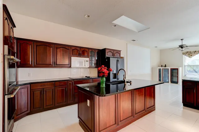 a kitchen with stainless steel appliances granite countertop a sink and cabinets