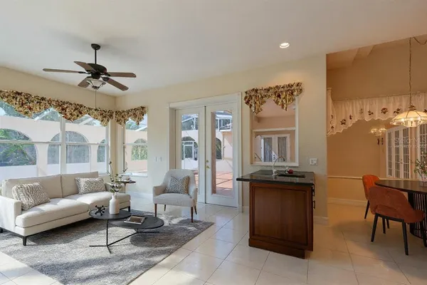a spacious bedroom with a bed and a chandelier