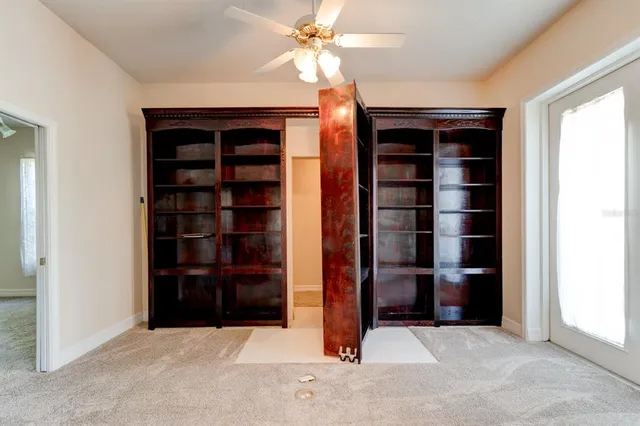 an empty room with closet and a window