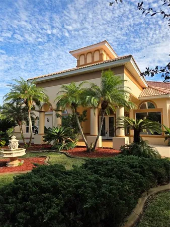 a view of a house with potted plants