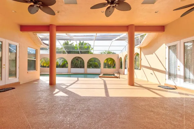 a view of empty room with a floor to ceiling window and a flat screen tv