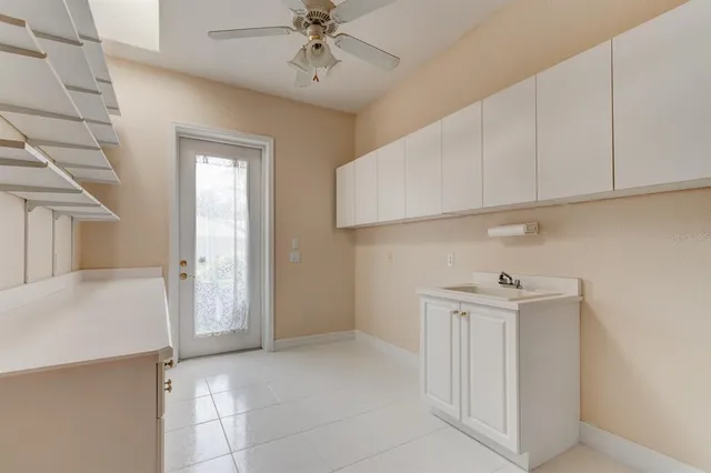 a view of an empty room with a kitchen