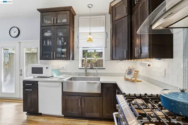a kitchen with a sink stove and cabinets