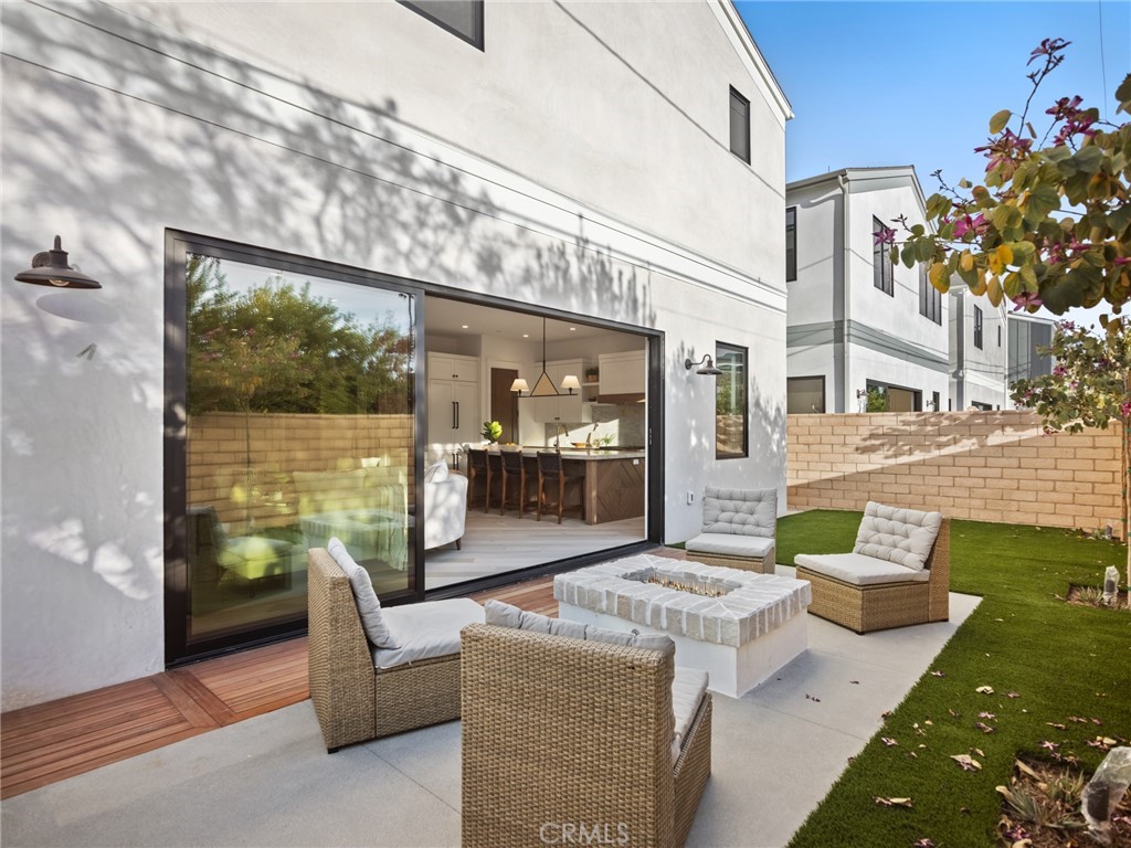 379 La Perle Place Costa Mesa, CA 92627 - Photo 7 of 8 a front view of a house with outdoor seating