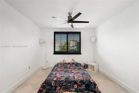 a bedroom with bed and a window