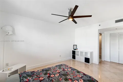 a view of a livingroom with wooden floor and kitchen view