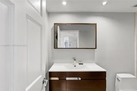 a bathroom with a sink vanity and mirror