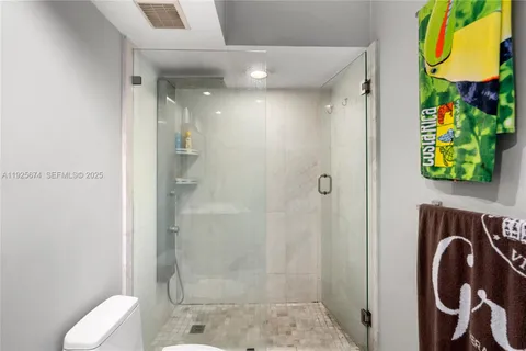 a bathroom with a toilet and a shower