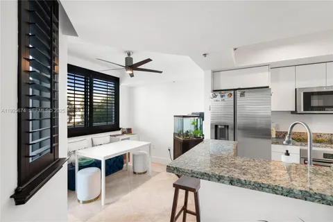 a kitchen with a sink a counter top space stainless steel appliances and a window