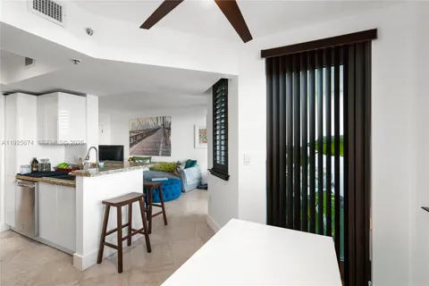 a kitchen with a refrigerator and a stove top oven
