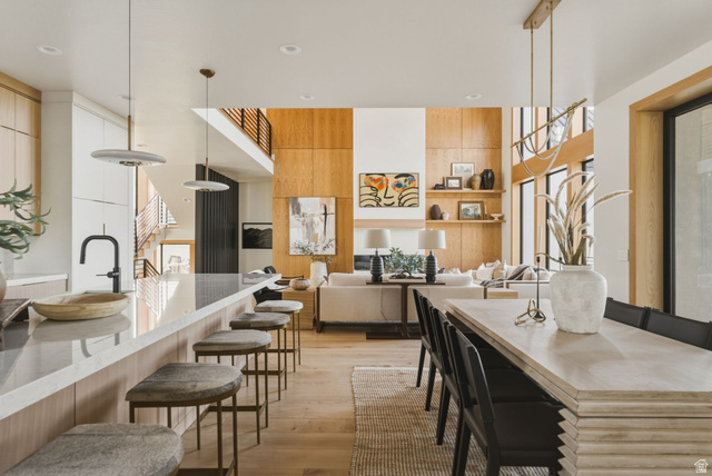 923 North Emery Lane Elk Ridge, UT 84651 - Photo 21 of 101 Expansive open-concept living space featuring wood-panel accent walls, high ceilings, and wood-finish flooring
