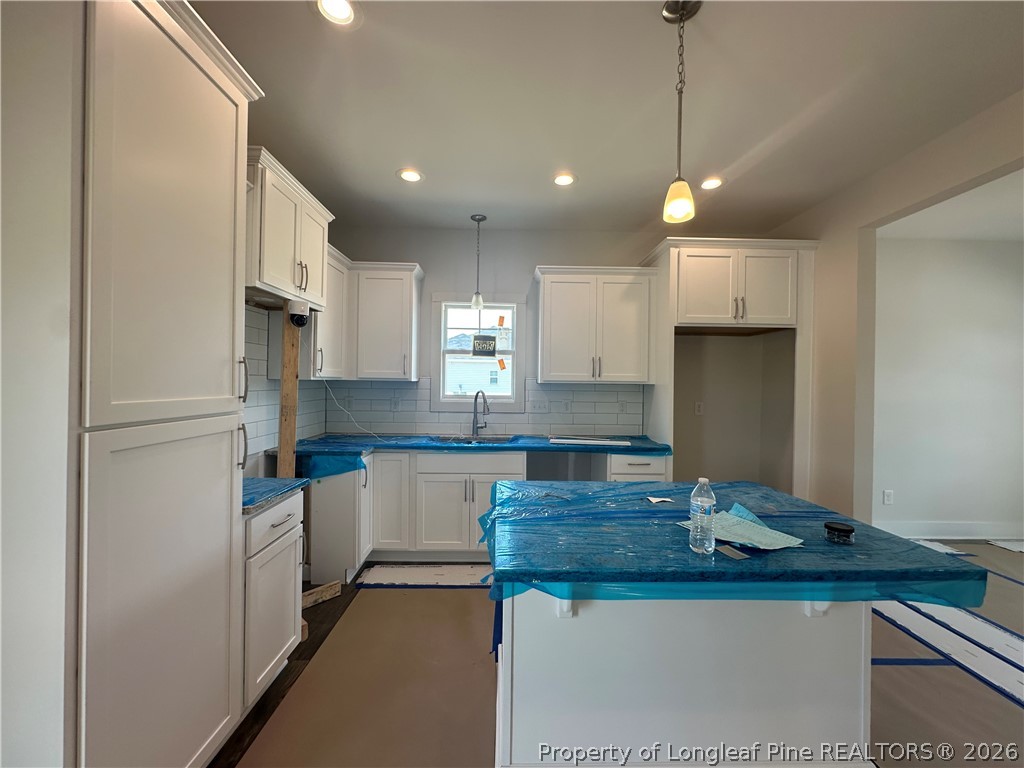 8383 Shannon Road Shannon, NC 28386 - Photo 5 of 17 a kitchen with kitchen island granite countertop a sink cabinets and refrigerator