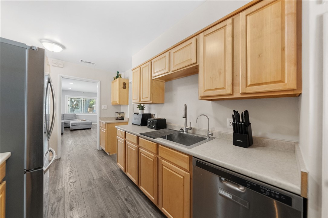 4869 Serrano Place Riverside, CA 92504 - Photo 25 of 40 Additional kitchen angle showcasing abundant cabinetry, workspace, and a clean, bright design.