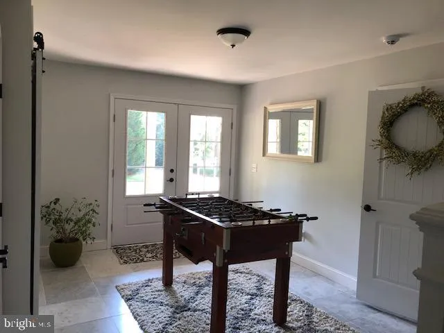 a kitchen with stainless steel appliances a sink a stove a refrigerator cabinets and dining table