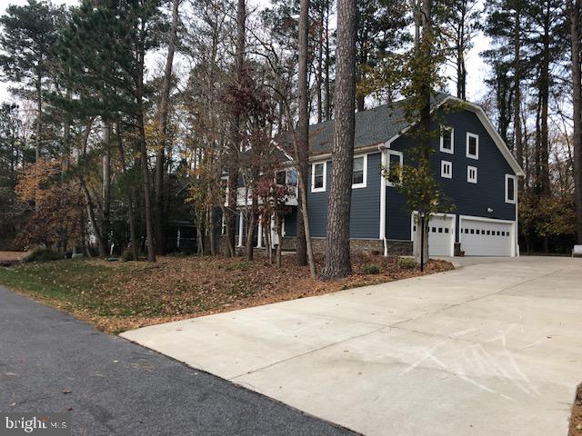 360 Bay Reach Rehoboth Beach, DE 19971 - Photo 27 of 28 a front view of a house with a yard and garage