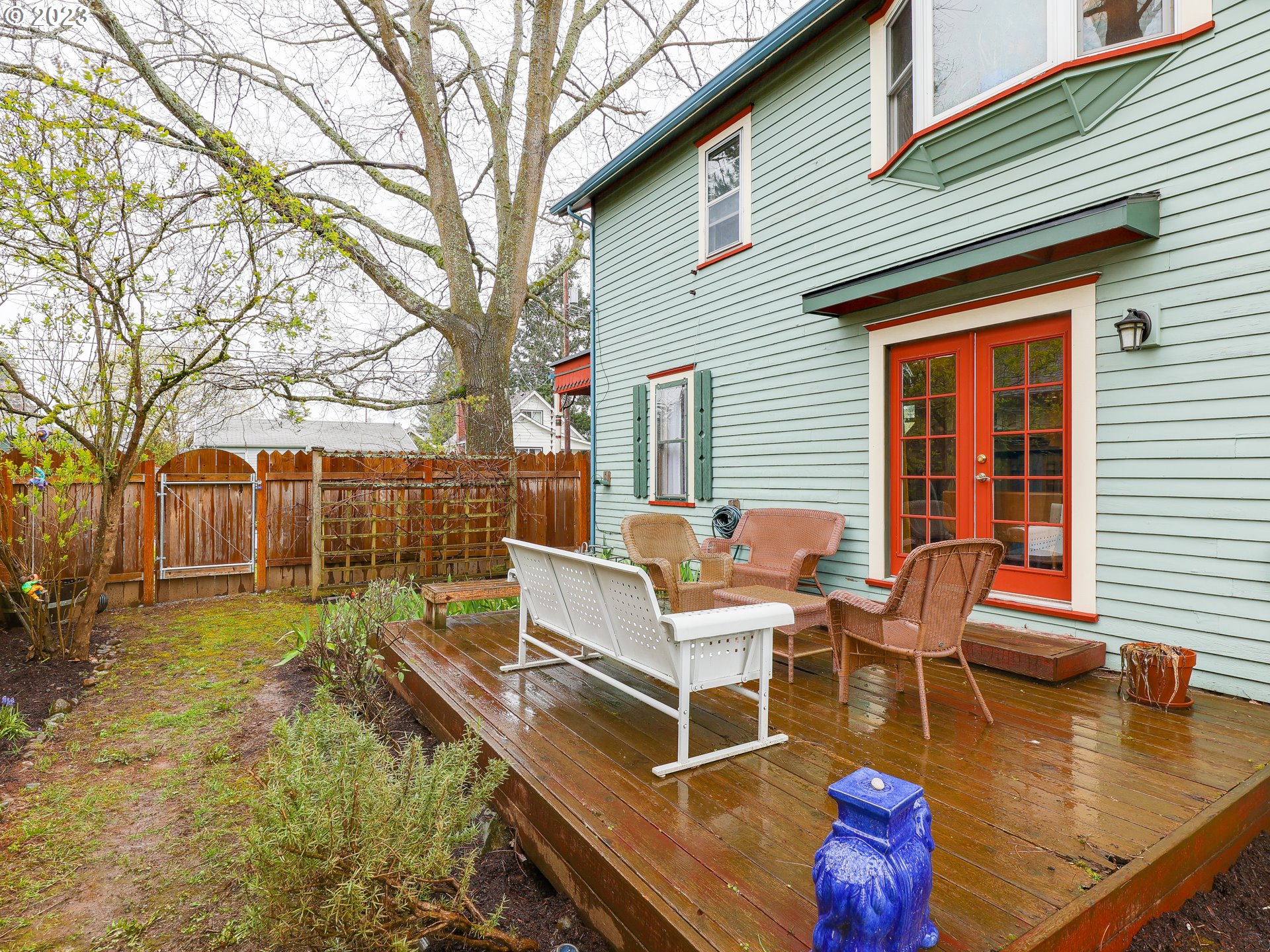 4936 Southeast 76th Avenue Portland, OR 97206 - Photo 41 of 47 a view of a patio with table chairs and wooden fence