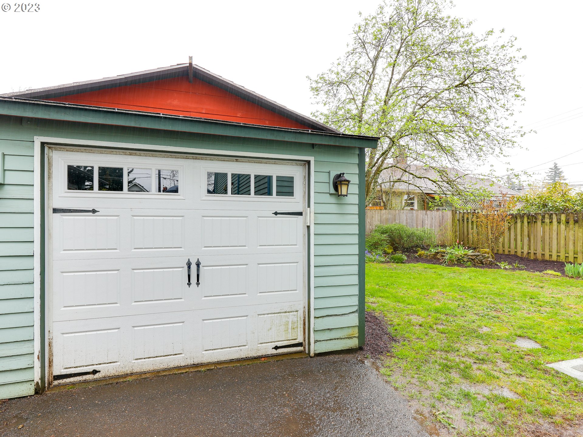 4936 Southeast 76th Avenue Portland, OR 97206 - Photo 43 of 47 a front view of a house with a yard and garage